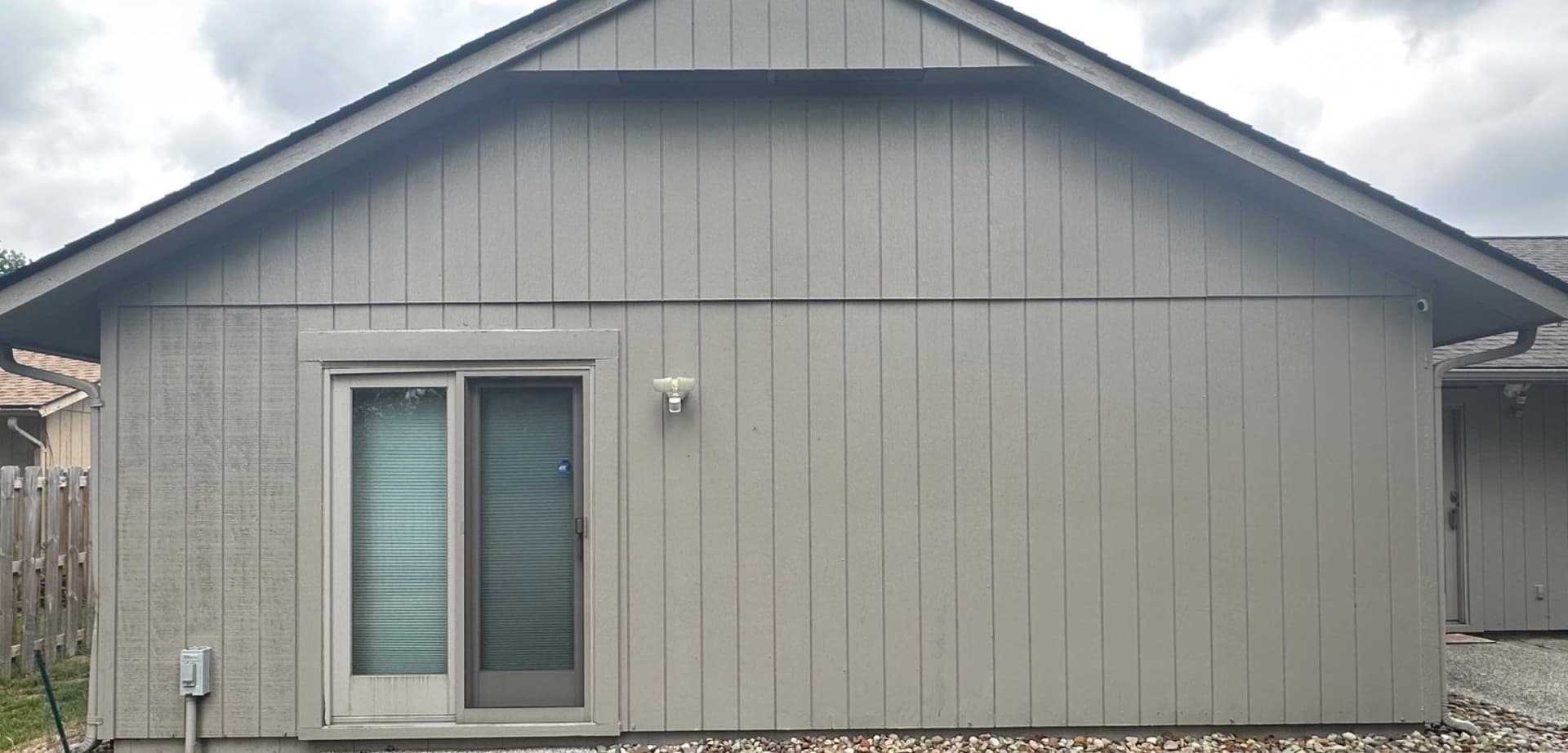 The same garage wall with a uniform gray finish, after