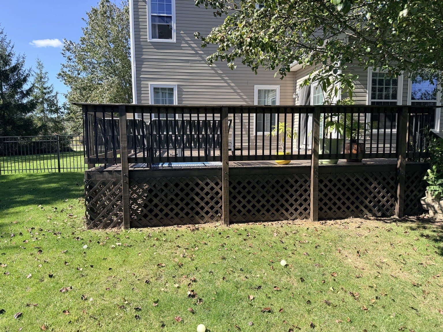 Backyard deck with railings and lattice skirting stained dark brown